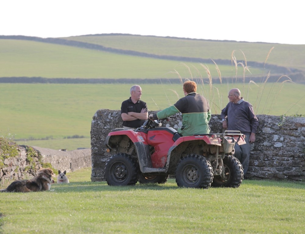 Man On Quad Bike Speaking To Local Insurance Advisor